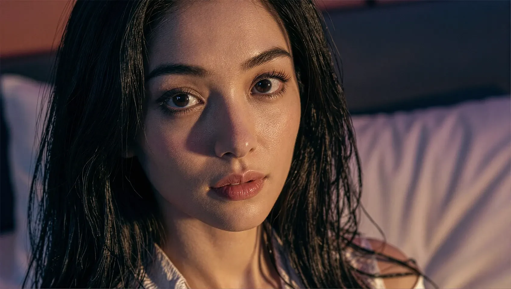 Night close-up of a fictional AI character's face, half of it falling into shadow
